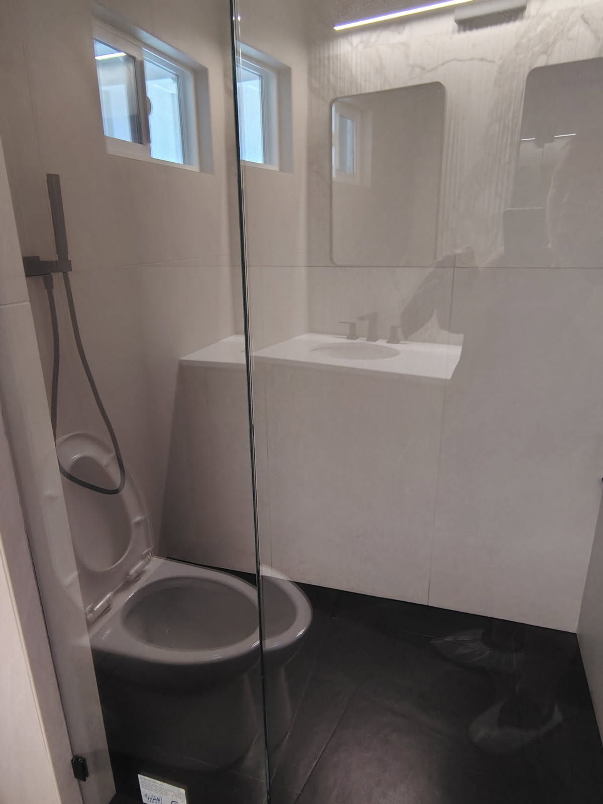 modern bathroom with glass enclosure and spotless sink after deep cleaning