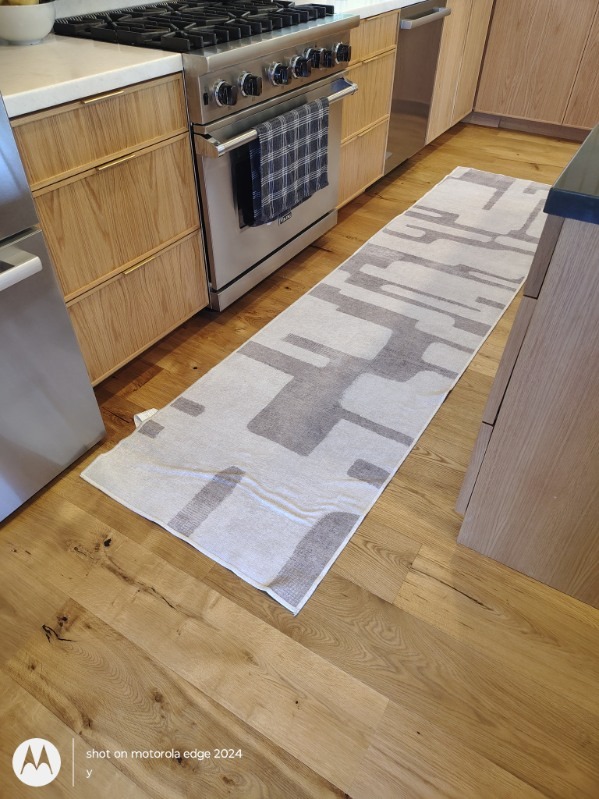 spotless hardwood kitchen floor and range after professional deep cleaning