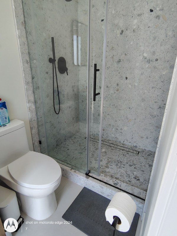 spotless glass shower enclosure and tile walls after deep cleaning